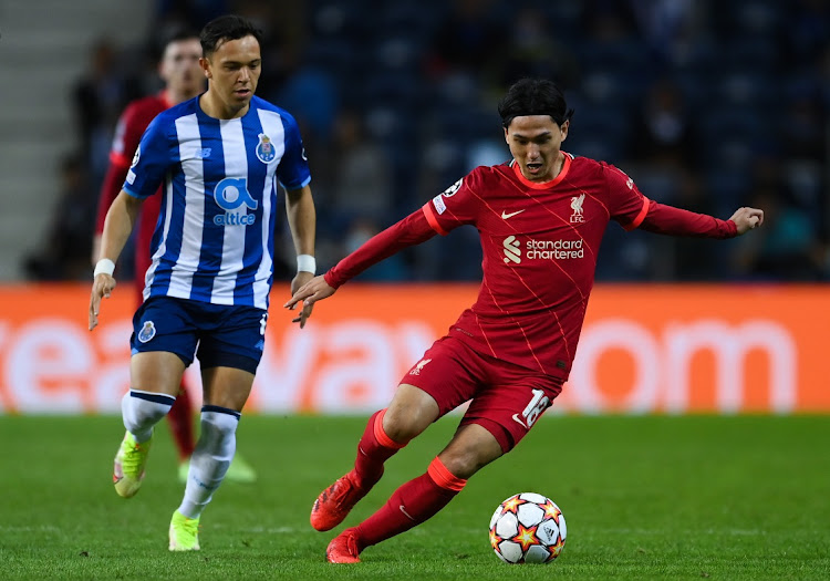 Takumi Minamino of Liverpool FC competes for the ball with Pepe of FC Porto during the UEFA Champions League group B match between FC Porto and Liverpool FC at Estadio do Dragao on September 28 2021 in Porto, Portugal. Picture: GETTY IMAGES/DAVID RAMOS