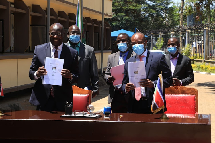 Governor Wycliffe Wangamati with Edward Mungai, the Chief Executive Officer at KCIC after signing the MoU in Bungoma town