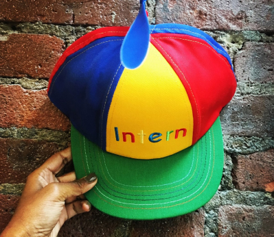 Intern hat against brick wall