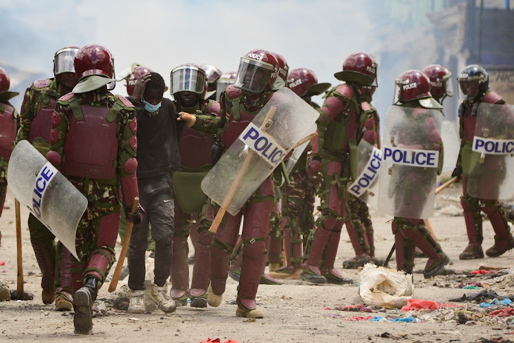 FILE PHOTO: Riot police officers detain a supporter of Kenya's opposition leader Raila Odinga of the Azimio La Umoja (Declaration of Unity) One Kenya Alliance, as they participate in a nationwide protest over cost of living and President William Ruto's government in Mathare settlement of Nairobi, Kenya on March 30, 2023.