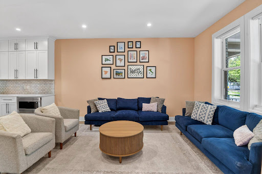 Living room with blue sofa and gray armchairs - House purchase in Washington, 4 bedrooms