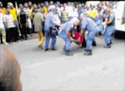 UNDER ARREST: Video footage of Mido Macia being  tied to the back of a van by police. Macia later died in police custody.  Photo: DAILY SUN