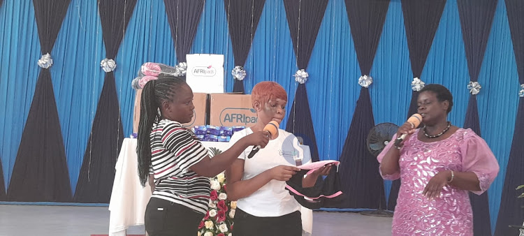 Bahari Sisters Project Assistant Catherine Muturi and Bahari Sisters Project Manager Audrey Ochieng (centre) demonstrating how to use a reusable pad during the Bahari Sisters Menstrual Health Forum in Githurai on February 17, 2024.