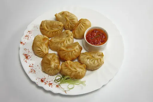 Pan Fried Veg Momos In Manchurian Sauce [6 Pieces]
