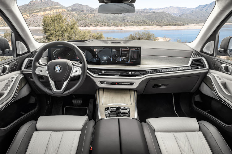 Massive BMW curved display dominates the interior.