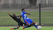 Terrence Dzukamanja of Orlando Pirates challenged by Lifa Hlongwane of Maritzburg United during their DStv Premiership match at Harry Gwala Stadium on October 20 2021 in Pietermaritzburg. 