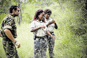 BUSH PATROL: Craig Spencer watches as Collet Ngobeni and Felicia Mogakane dismantle a snare