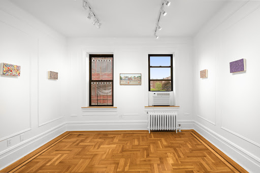 White room wooden floor, artwork on walls in this luxury apartment / penthouse for sale in Queens ($388,888)