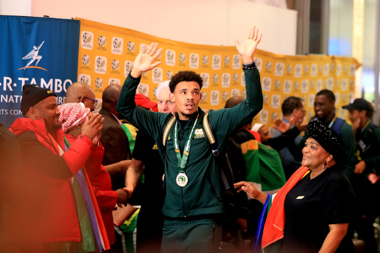 Bafana Bafana goalkeeper and captain Ronwen Williams greets fans as the team arrives from Afcon.