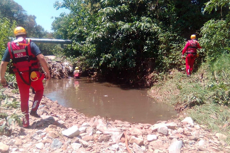 Emergency rescue members search the Jukskei River.