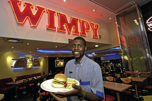 A waiter serves a hamburger at a Wimpy restaurant. A patron who visited Wimpy at Clearwater Mall caused a Twitter storm when she labelled a female Zimbabwean waiter an alien.