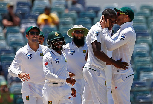 First Test cricket match - WACA Ground, Perth, Australia - 7/11/16. South Africa's Kagiso Rabada is kissed by team captain Faf du Plessis as they celebrate dismissing Australia's Mitchell Starc at the WACA Ground in Perth. REUTERS/David Gray