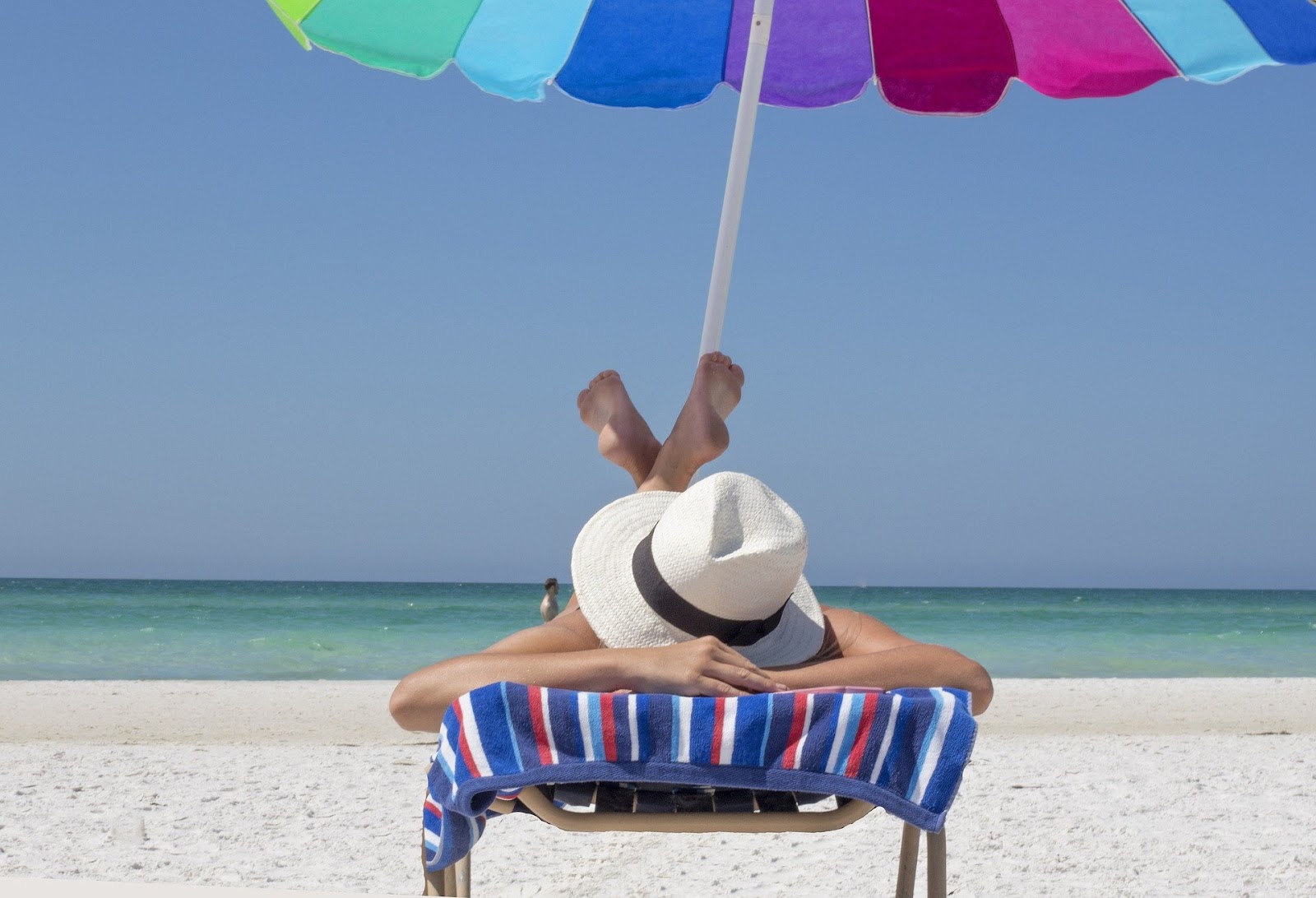 female lounging under the shade on the beach