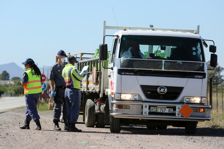 Drivers are checked by law-enforcement officials at a roadblock outside Aberdeen, near Beaufort West.