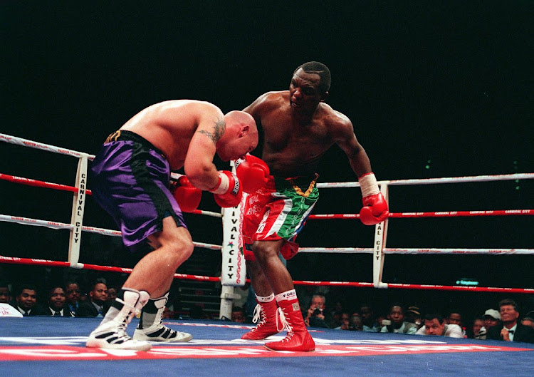 Dingaan Thobela vs Glenn Catley at Carnival City, 1 September 2000. Thobela slings out his left at Catley.