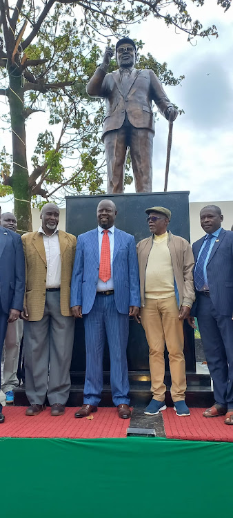 Masinde Muliro's son, Mwambu Mukasa, Trans Nzoia Governor Patrick Khaemba, former Cabinet minister Musikari Kombo and Trans Nzoia county commissioner Samson Ojwang next to Masinde Muliro's statue at the new Kitale Bus Park.