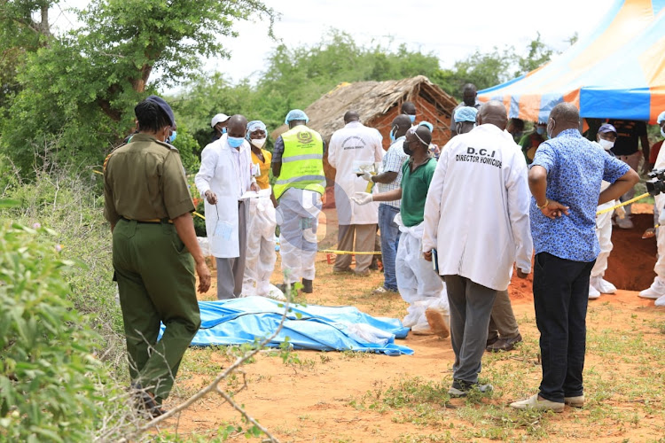 Detectives exhuming bodies in Shakahola forest on June 12, 2023.