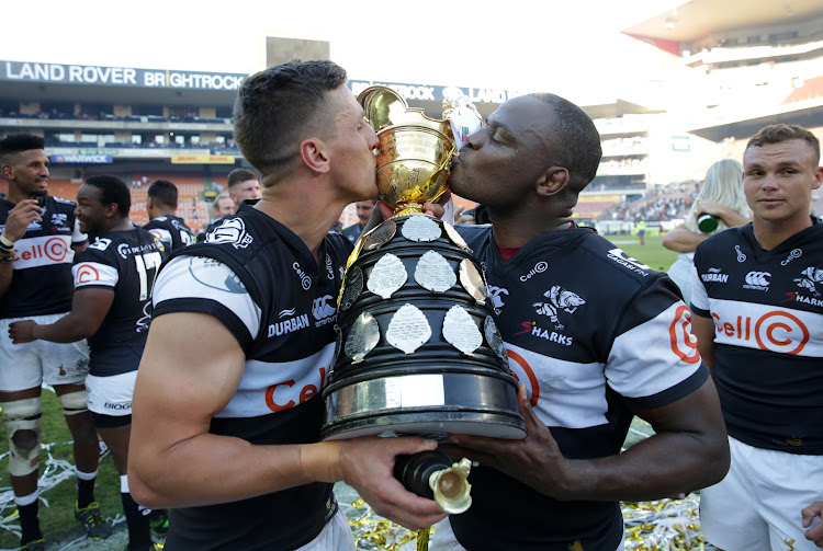 Louis Schreuder of the Cell C Sharks (L) and Chilliboy Ralepelle (R) celebrate with the Currie Cup trophy after winning the final against Western Province at Newlands Stadium in Cape Town on October 27, 2018.