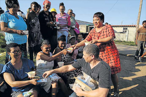 COMPASSION: Errol and Dianna Botha from The Lord’s Kitchen hand out food to more than 100 Egoli women as part of Women’s Month