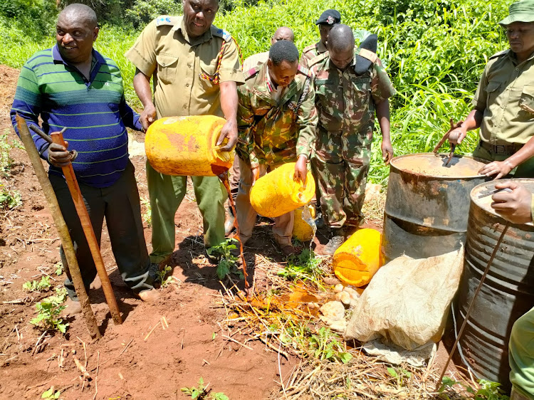 Security agents destroy illicit brews confiscated along River Chania in Gatanga, Murang'a county, on April 26, 2023.