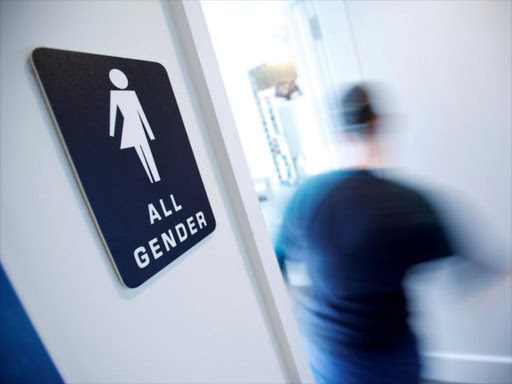 A bathroom sign welcomes both genders at the Cacao Cinnamon coffee shop in Durham, North Carolina, United States on May 3, 2016. /REUTERS