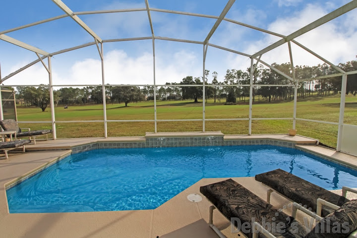 Highlands Reserve villa in Davenport with a scenic golf course view from the private pool deck