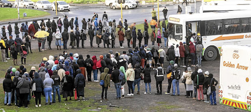 Commuters in Nyanga queue to catch a bus to go to work. Picture: BRENTON GREACH/GALLO IMAGES