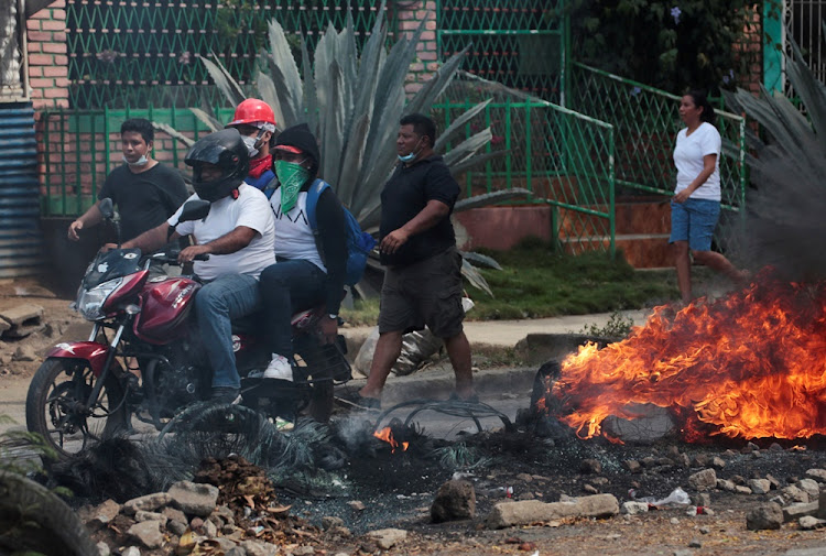 Demonstrators past a barricade as they take part during a protest over a controversial reform to the pension plans of the Nicaraguan Social Security Institute (INSS) in Managua, Nicaragua on April 21, 2018.