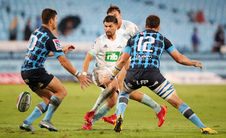 Otere Black is sandwiched by a challenge from Morne Steyn (L) and captain Burger Odendaal (R) during a Super Rugby match between the Blues and the Vodacom Bulls at Loftus on February 22 2020.