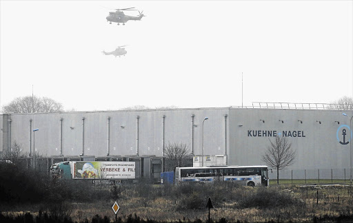 KILLING FIELD: Security forces helicopters hover above the industrial area northeast of Paris on Saturday where the two Charlie Hebdo terrorists were shot dead