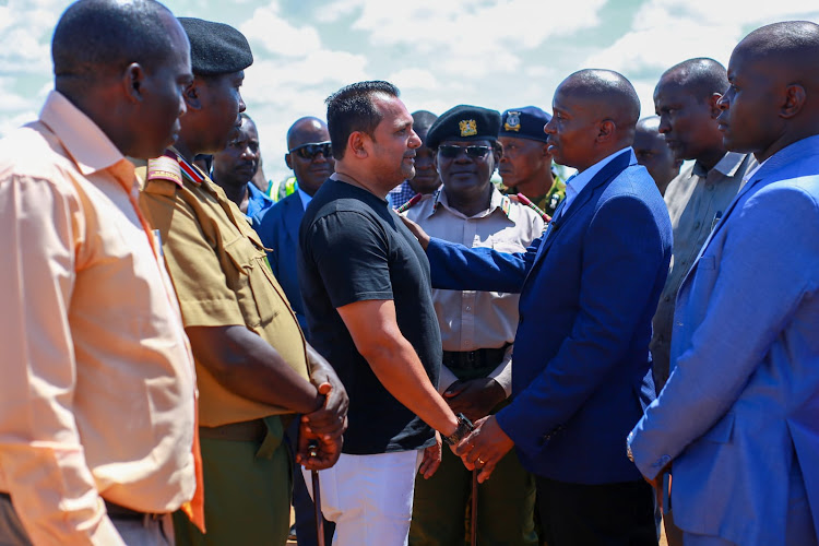 Mombvasa Cement's Imtiaz Sayani speaks with Interior CS Kithure Kindiki at Shakahola on Tuesday.