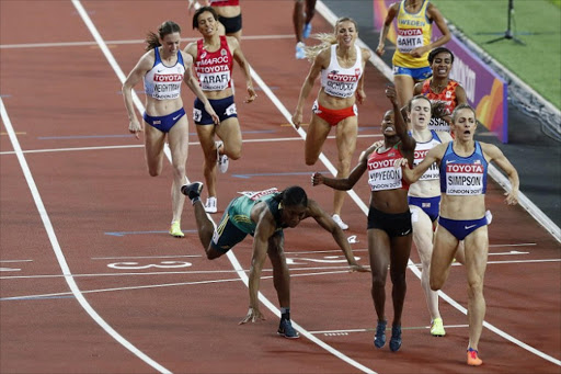 Kenya's Faith Chepngetich Kipyegon (C) celebrates winning as South Africa's Caster Semenya (L) grabs third, and US athlete Jennifer Simpson (R) second place in the final of the women's 1,500m athletics event at the 2017 IAAF World Championships at the London Stadium in London on August 7, 2017. Image: Adrian DENNIS / AFP
