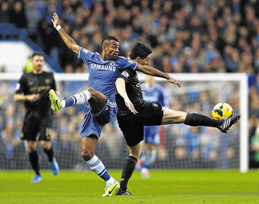 YOU PUT YOUR LEFT LEG IN: Chelsea's Ashley Cole, left, challenges Manchester City's Samir Nasri during the English Premier League match at Stamford Bridge in London yesterday. Chelsea won 2-1