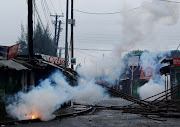 Smoke rises from tear gas fired by riot policemen to disperse supporters of Kenyan opposition leader Raila Odinga protesting the presidential election re-run in Kibera slums of Nairobi, Kenya October 26, 2017.