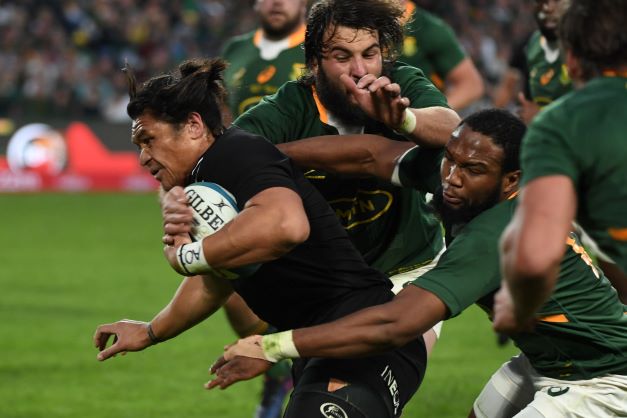 Caleb Clarke of New Zealand tackled by Lukhanyo Am of the Springboks during the Rugby Championship match at Emirates Airline Park on August 13.