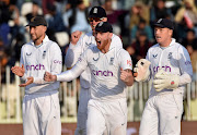 England's players celebrate the dismissal of Pakistan's Agha Salman. 