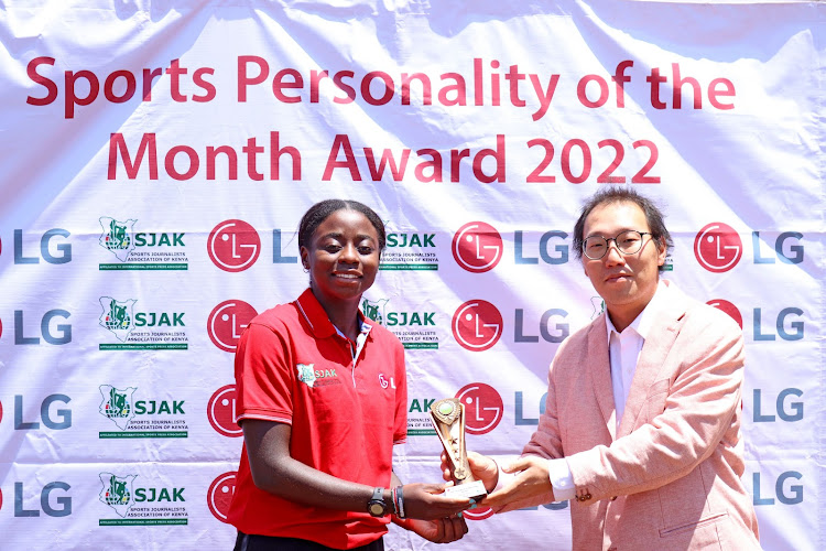 Tennis star Angela Okutoyi recieves a trophy from LG electronics marketing director Changhyun Kim at the Nairobi Club