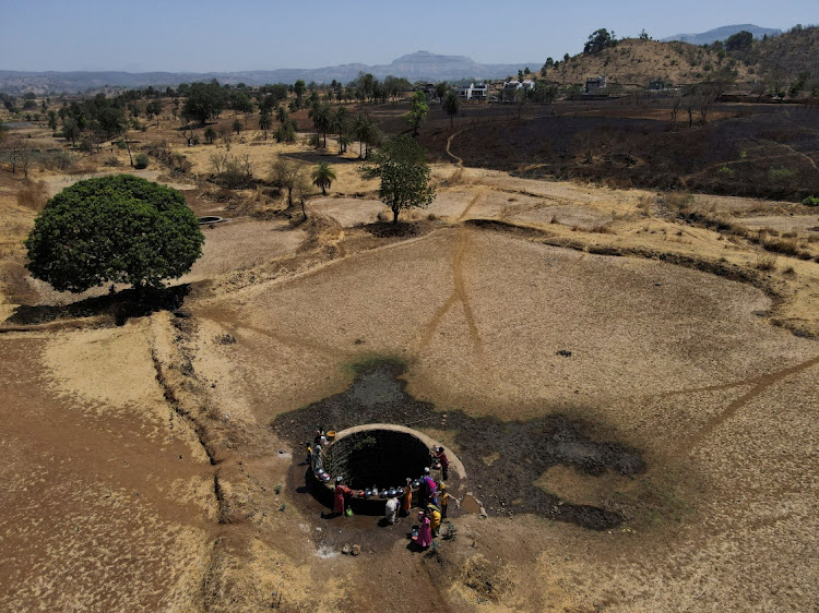 A drone view of women drawing water from a well on a hot day in Kasara, India, on May 1 2024.