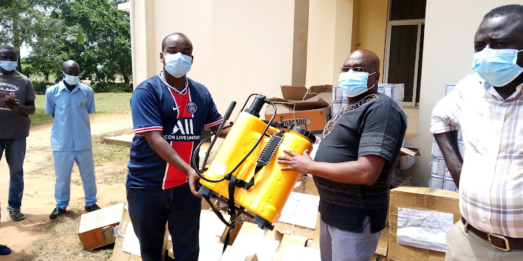 County executive for health Francis Gwama receives medical supplies from the Australian firm community health officer Emanuel Kioli at Kwale heath headquarters in Matuga sub-county on Thursday, April 22, 2021.