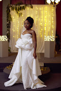 Sphilile (Tee Xaba)'s bridal gown featured a detachable overskirt which gave the effect of a train as she walked down the aisle.