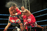 BSA nominee Gideon  Buthelezi unleashes punches as  Angel Aviles flinches during their IBO bantamweight title fight   in Ekurhuleni in  April.