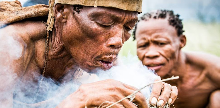 Two guides demonstrate survival skills on the Bushman Walk from the Kalahari Plains Camp.