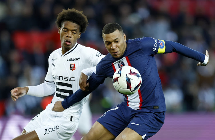 Paris St Germain's Kylian Mbappe holds off Stade Rennes' Warmed Omari in action in their Ligue 1 match against at Parc des Princes in Paris in France in March 2023.