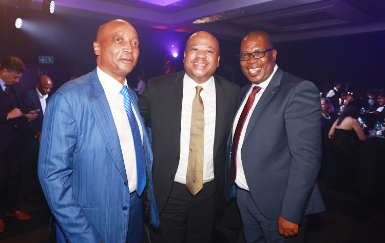 From left, Confederation of African Football president Patrice Motsepe, Kaizer Chiefs football manager Bobby Motaung and Gauteng premier Panyaza Lesufi during the induction dinner for Dr Kaizer Motaung (not pictured) into the South African Hall of Fame at Montecasino Ballroom in Johannesburg on Saturday.