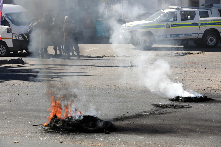 Tyres burn during a service delivery protest in Heldedal, Bloemfontein. The writer says as much as some used their right not to vote, they must not close roads and stone buses when things don't go their way.