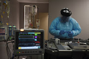 Christopher Peter, 32, a respiratory specialist is seen as medical professionals treat people infected with the coronavirus disease (Covid-19) at United Memorial Medical Center in Houston, Texas, US, November 12, 2020.  