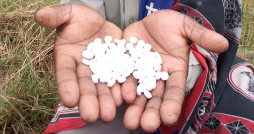 A sangoma holds Western tablets. File picture