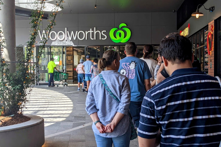 Shoppers line up outside a Woolworths store as greater Brisbane has been ordered into a snap three-day lockdown after four more cases of the coronavirus disease (Covid-19) emerged in the community, in Brisbane, Australia, March 29, 2021.