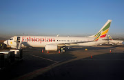 Workers service an Ethiopian Airlines Boeing 737-800 plane at the Bole International Airport in Ethiopia's capital Addis Ababa, January 26, 2017.