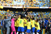 Mamelodi Sundowns coach Rulani Mokwena hoisted by his players after the African Football League final against Wydad AC at Loftus Versfeld on November 12 2023.